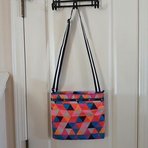 LeSportsac crossbody bag with a multi-colored geometric pattern adjustabls strap